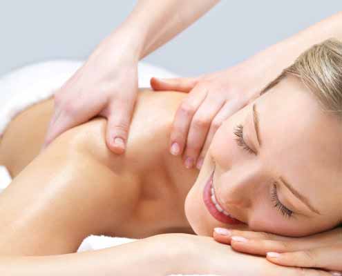 Receiving massage therapy by a registered massage therapist at evolve Massage & Wellness in Hamilton.