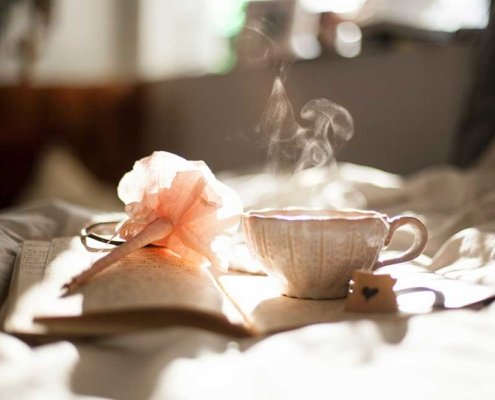 Relaxing with tea, reading on a yoga staycation